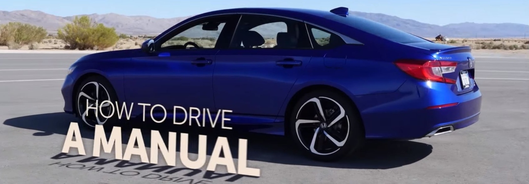 How to drive a manual text beside blue Honda sedan