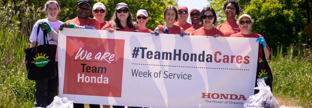 Honda employees holding #TeamHondaCares sign