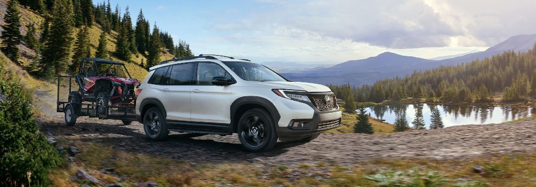 2020 Passport towing a trailer with a recreational vehicle in it