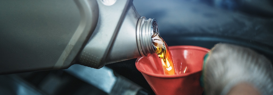 pouring oil into a funnel