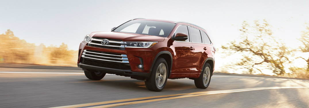 red 2018 Toyota Highlander driving on open road