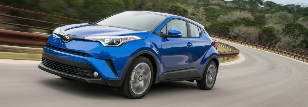 blue 2018 Toyota C-HR driving around a corner