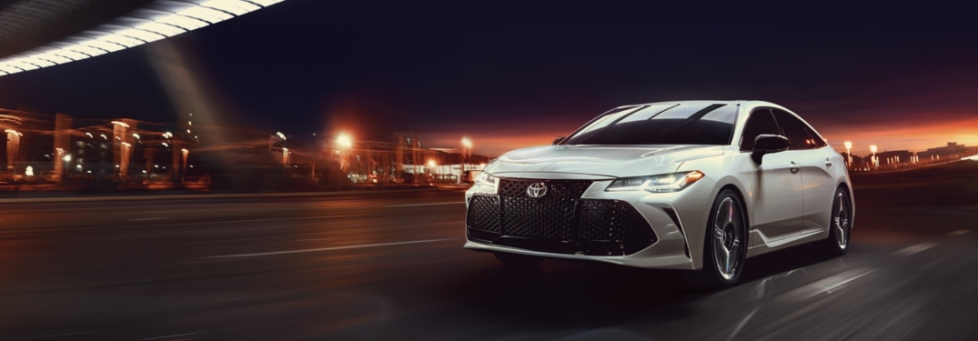 White 2019 Toyota Avalon driving at night