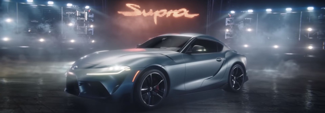 2020 Toyota Supra parked below Supra sign