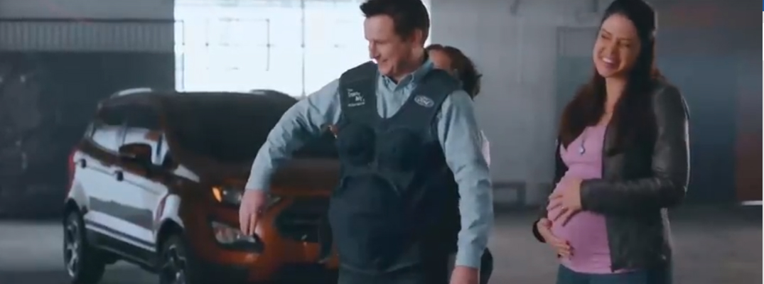 Man Wearing a Ford Pregency Suit in Front of a 2018 Ford EcoSport