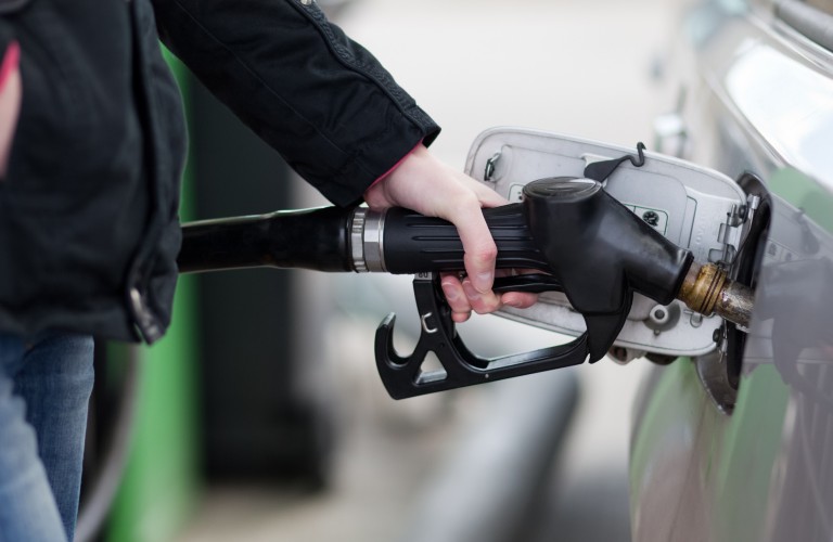 a hand holding a gas station pump