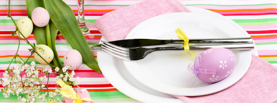 A stock photo of an intricately decorated table for an Easter meal.