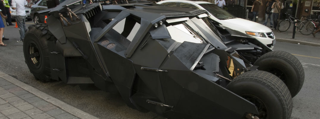 A stock photo of the Bat-Mobile parked on a street.