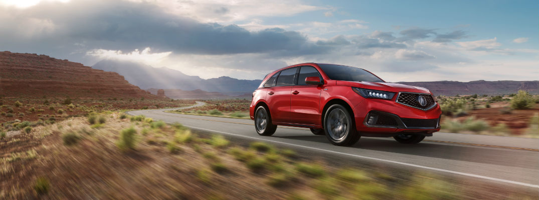 A front right quarter photo of the 2019 Acura MDX A-Spec driving through the desert.