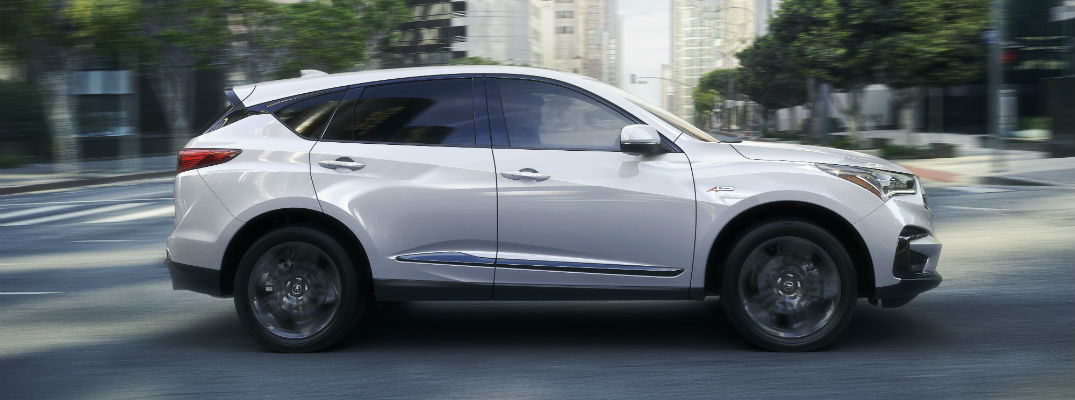 A right profile photo of the 2019 Acura RDX parked in a city.