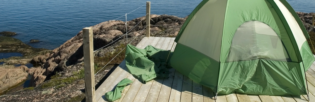 Tent set up on a dock overlooking water