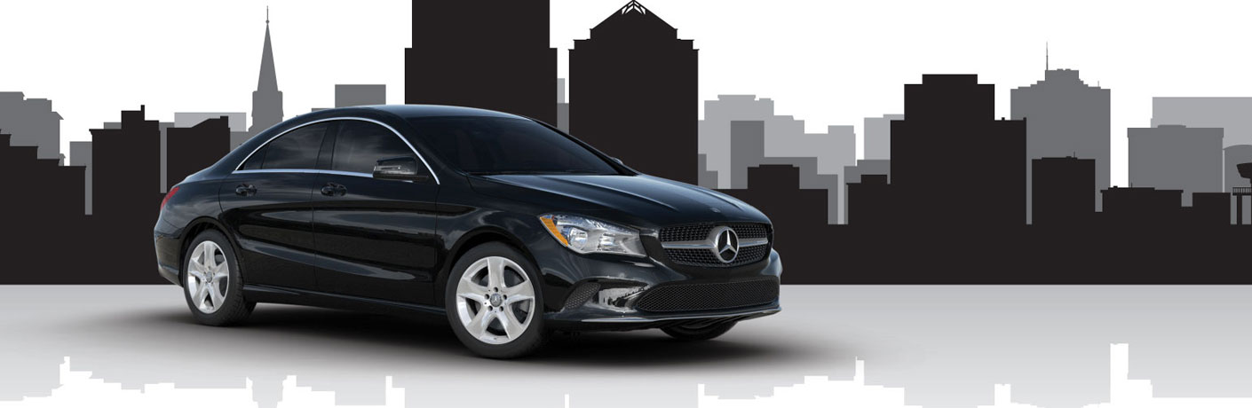 Mercedes-Benz CLA parked in a showroom with a silhouette of a skyscraper behind it.