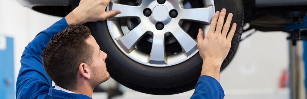 Service technician aligning tires