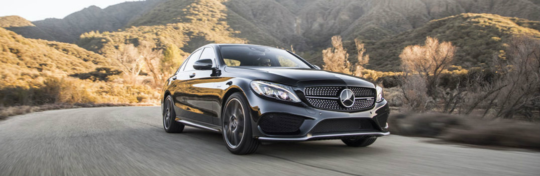 2018 Mercedes-Benz C-Class black driving on the highway hilly background