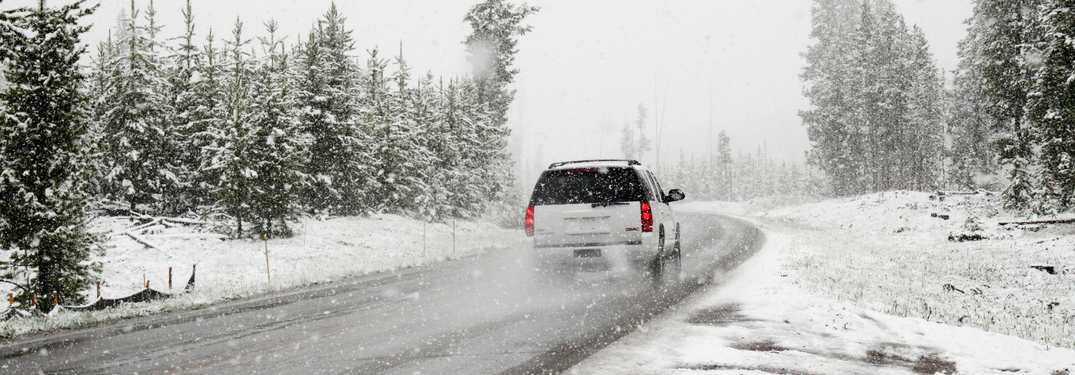SUV Drives down road in winter