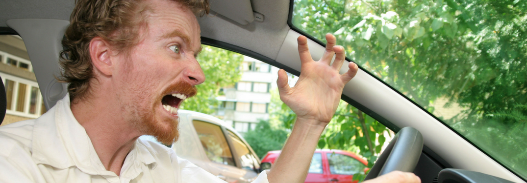 Man gets frustrated behind wheel of car