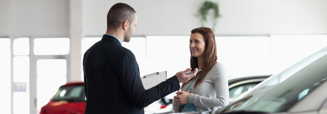 Car salesman talking with a car shopper at the dealership