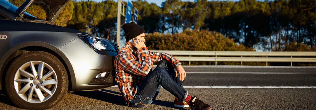 Man stuck on the side of the road with his car