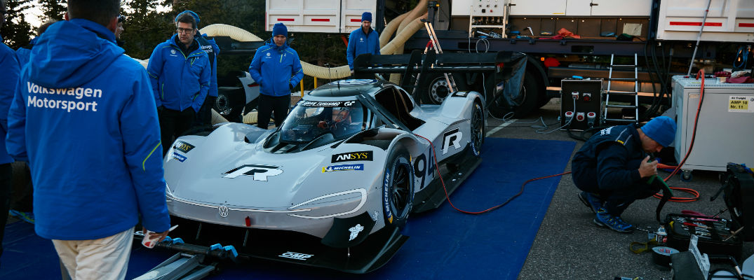 A photo of the VW racing team recharging the concept car's batteries.