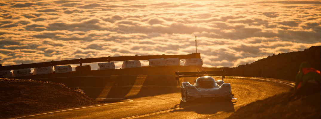 A photo of the VW Pikes Place car breaking through the clouds at the annual race.