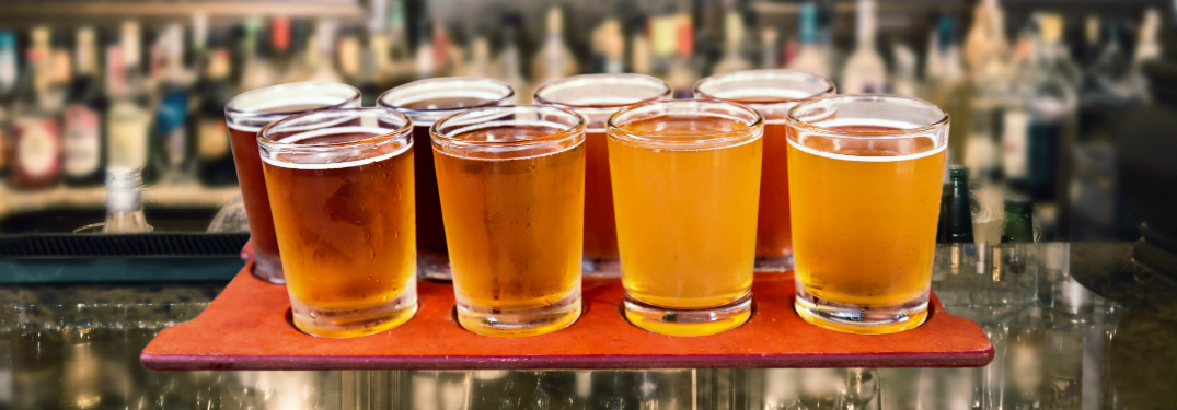 Flight of different beers at a bar