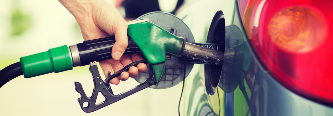 Woman filling her car up with gas