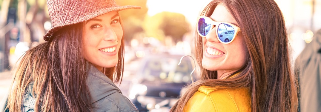Two young women turning around and smiling