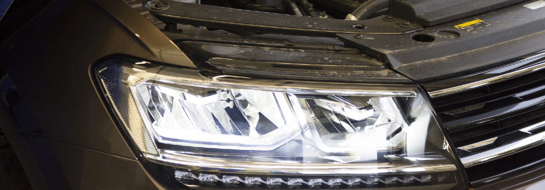 person adjusting car headlight