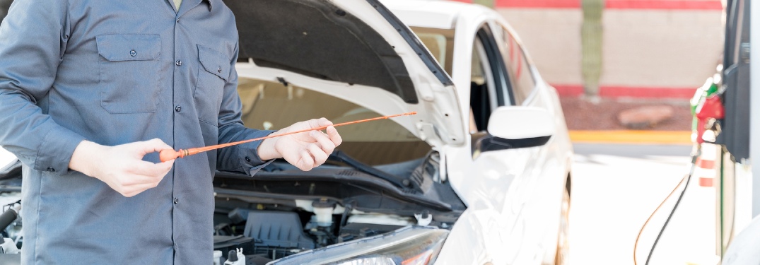 Person checking oil dipstick