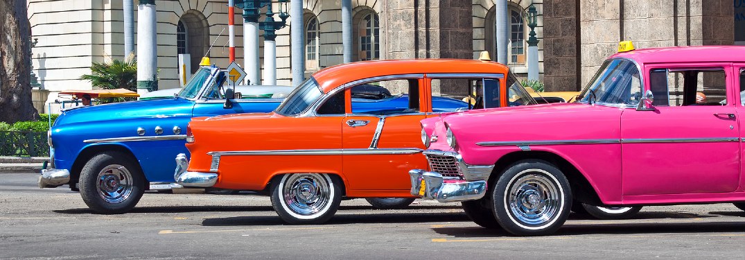 three bright classic cars in Havana, Cuba