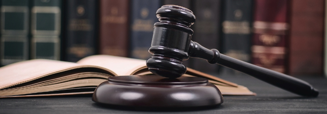 Gavel resting in front of law books