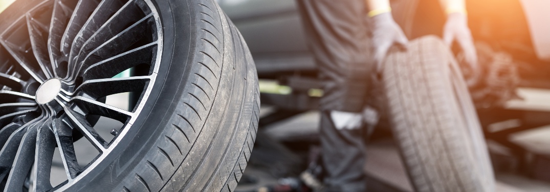 Person changing tires on a vehicle