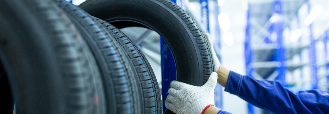 person pulling new tire off of rack
