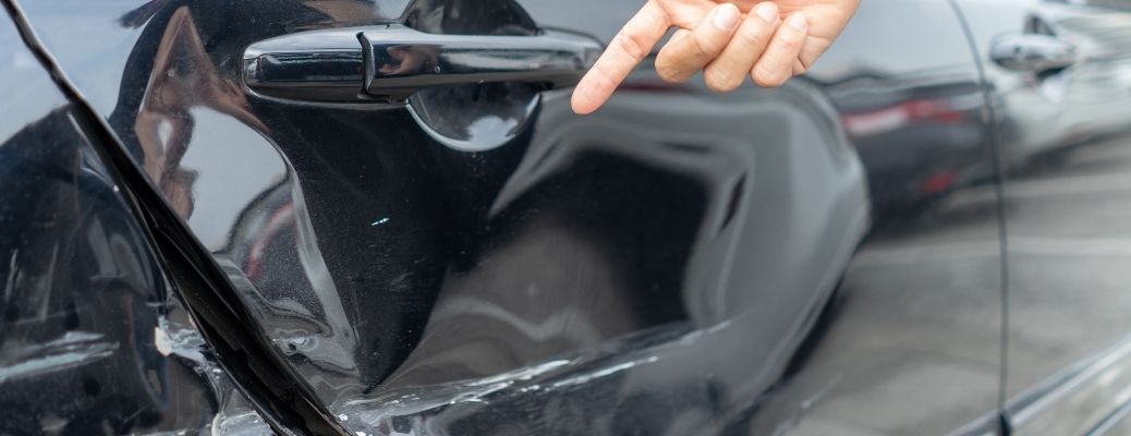Stock image of a dented car