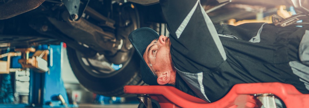 Mechanic working under car