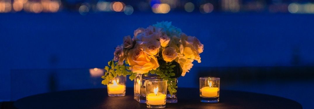 Set up of a romantic dinner set against a beautiful evening skyline