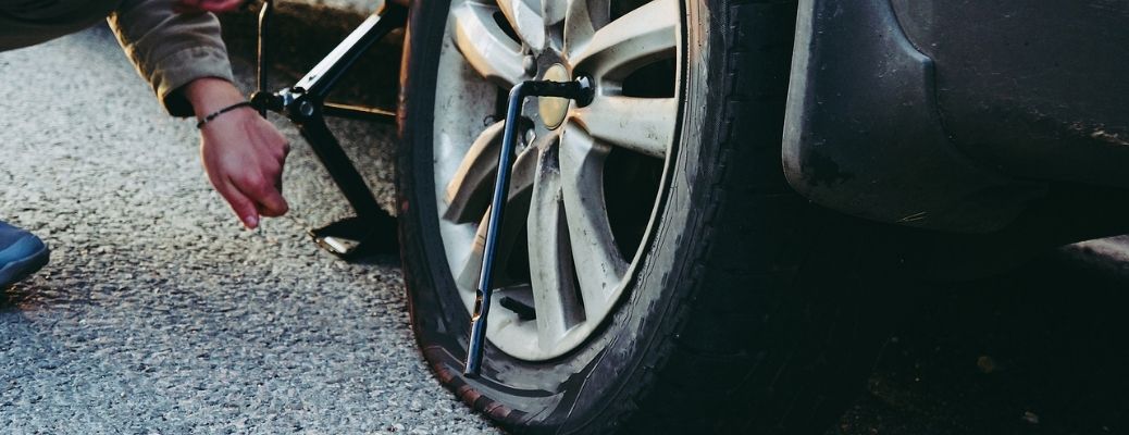 View of a flat tire being changed