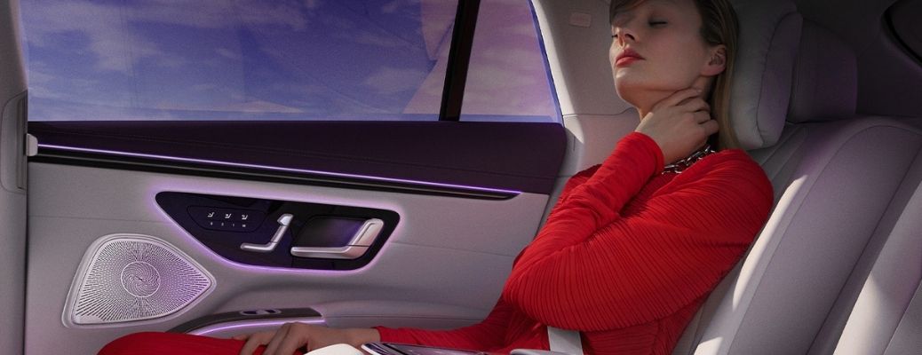 A lady in red sitting inside the mercedes benz