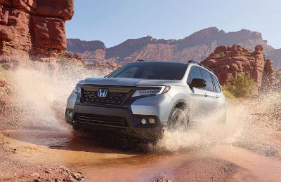 2019 Honda Passport exterior front fascia and drivers side splashing through puddle