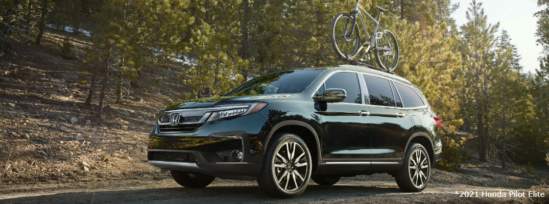 Green 2021 Honda Pilot Elite with bike on roof