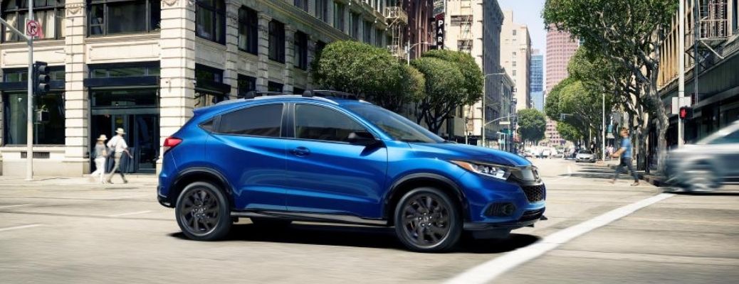 The 2022 Honda HR-V cruising through a bright and sunny road