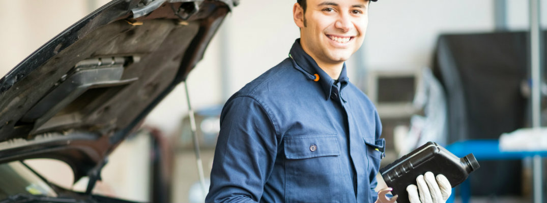 Mechanic holding a bottle of engine oil