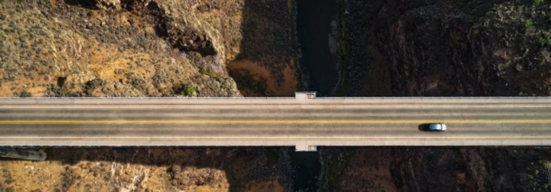 VW Taos as a tiny spec on a bridge