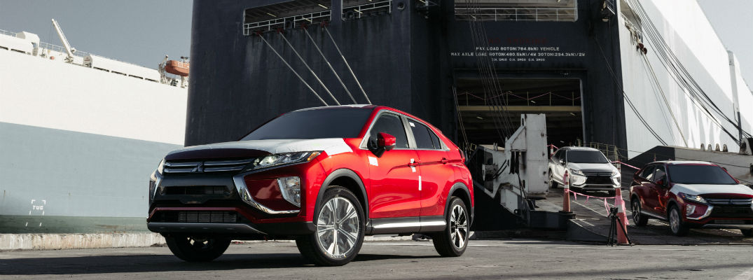 A photo of several models of the 2018 Mitsubishi Eclipse Cross being unloaded from a ship.