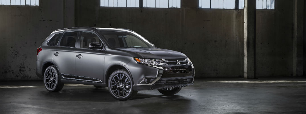 A right front quarter photo of a 2018 Mitsubishi Outlander Limited Edition in a warehouse