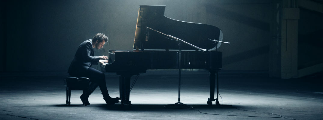 A photo of a musician playing the piano for a new Mitsubishi commercial for the 2018 Eclipse Cross.