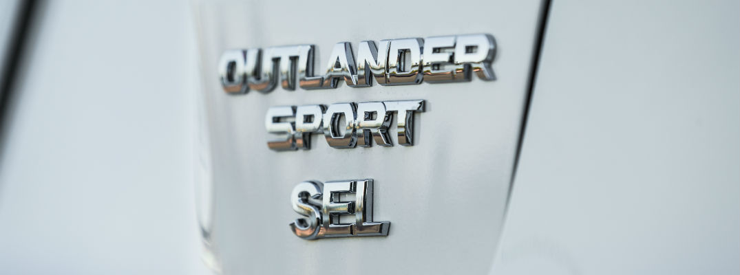 A close up photo of the Outlander Sport badge worn by the 2018 Mitsubishi Outlander Sport.