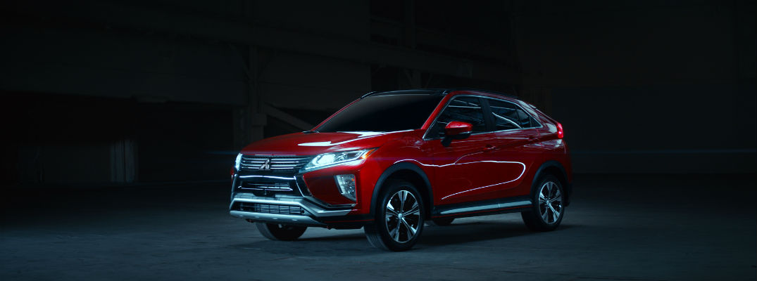 A left profile photo of the 2018 Mitsubishi Eclipse Cross in a dark room.