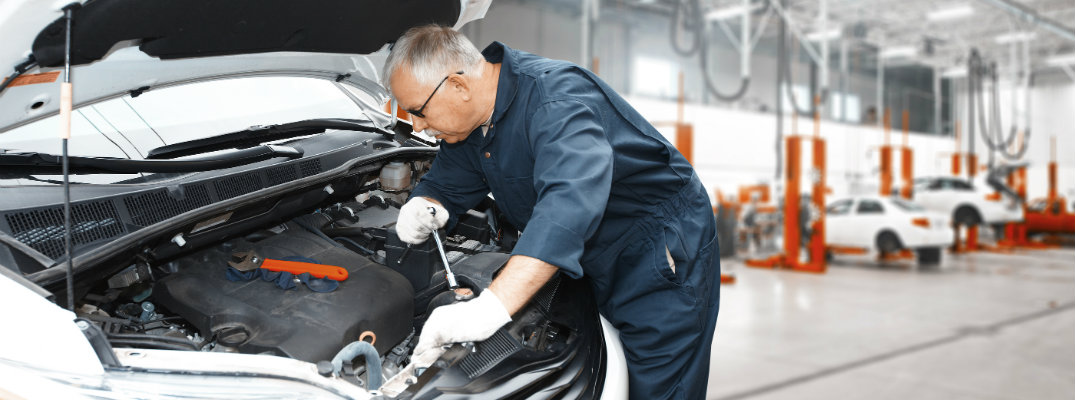 Mechanic working under the hood of a car