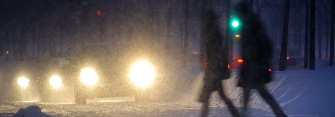 A couple crossing a street in winter